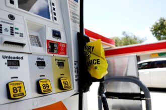 A gas station in the United States in white and orange colors