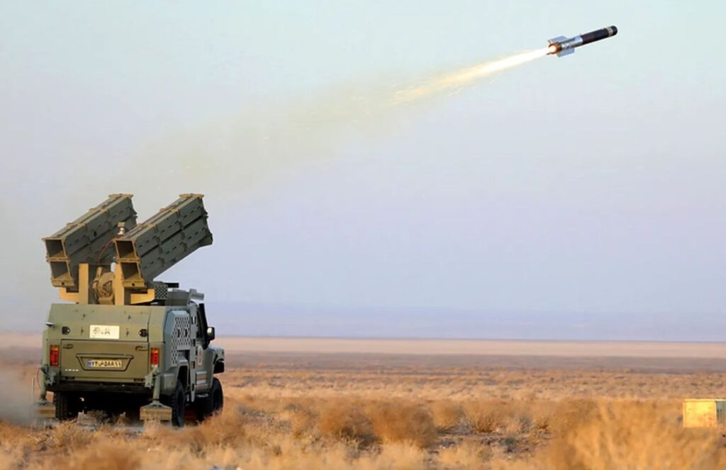 An Iranian military vehicle launching a rocket coming directly out of a weapon mounted in its trunk