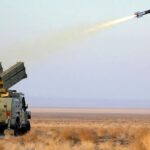 An Iranian military vehicle launching a rocket coming directly out of a weapon mounted in its trunk