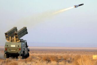 An Iranian military vehicle launching a rocket coming directly out of a weapon mounted in its trunk