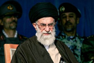 The late Iranian leader in a meeting with his men, with several of his military leaders standing behind him