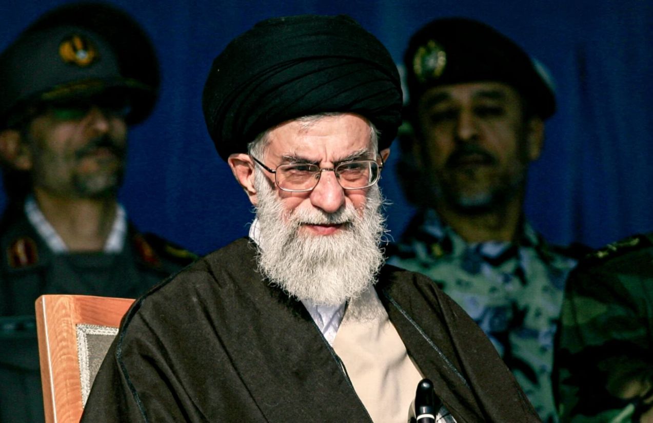 The late Iranian leader in a meeting with his men, with several of his military leaders standing behind him