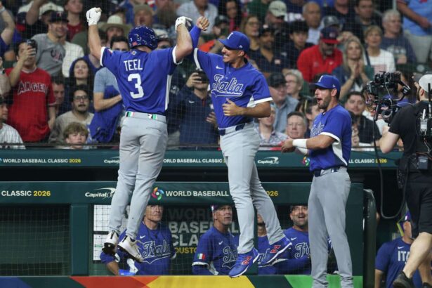 The Italian team celebrating together after scoring several runs against Team USA