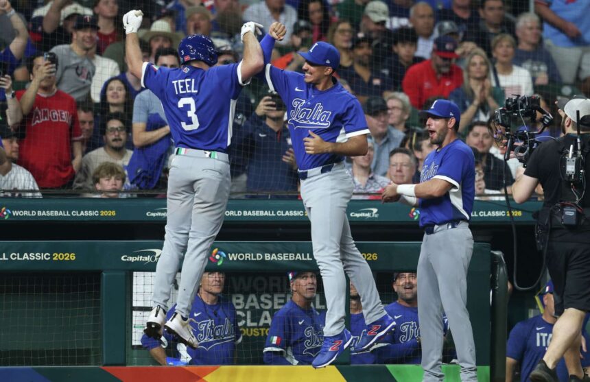 The Italian team celebrating together after scoring several runs against Team USA