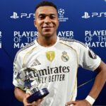 The French forward holding a UEFA Champions League match trophy after the victory