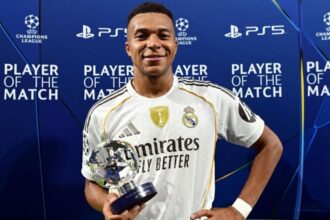 The French forward holding a UEFA Champions League match trophy after the victory