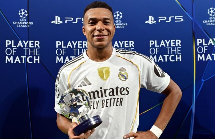 The French forward holding a UEFA Champions League match trophy after the victory