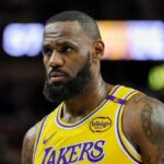 LeBron James with a very serious expression walking in the middle of a game