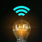 A light bulb turned on in the middle of the darkness with an internet signal above it