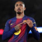 The Brazilian star pointing to the FC Barcelona crest on his jersey