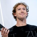 Mark in the middle of a conference speaking with many people who came to see and meet him