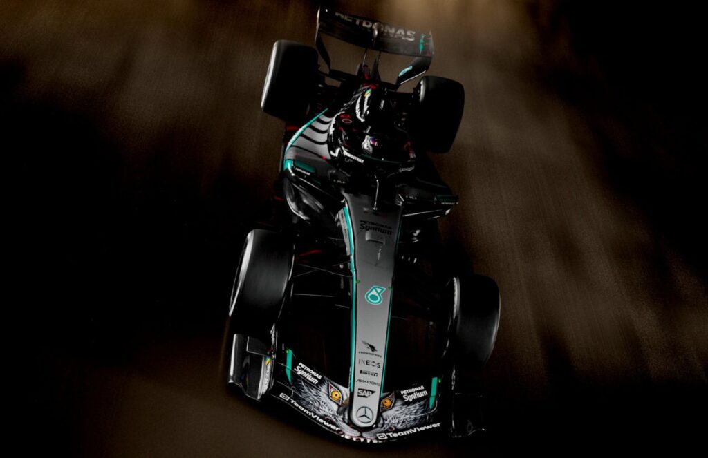 A Formula 1 Mercedes-Benz car with a Japanese dragon drawing on its front wings