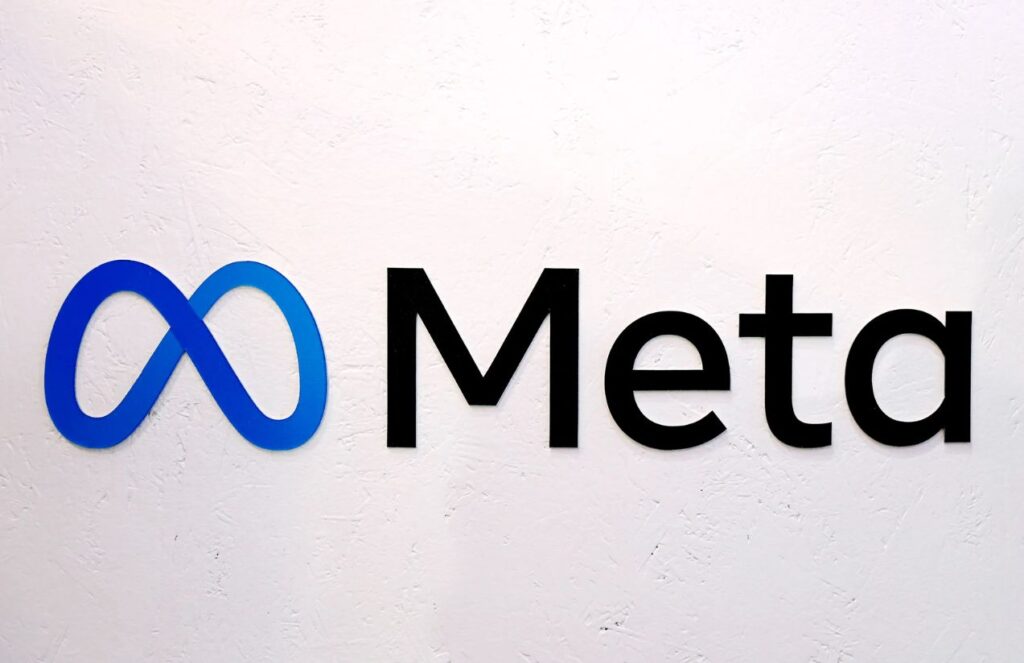 A wall with the logo and the word "Meta" in black