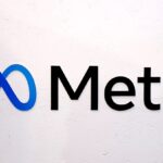 A wall with the logo and the word "Meta" in black