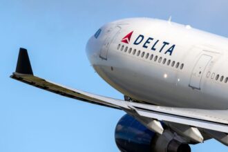 the front part of a Delta airplane being photographed while the aircraft is in flight