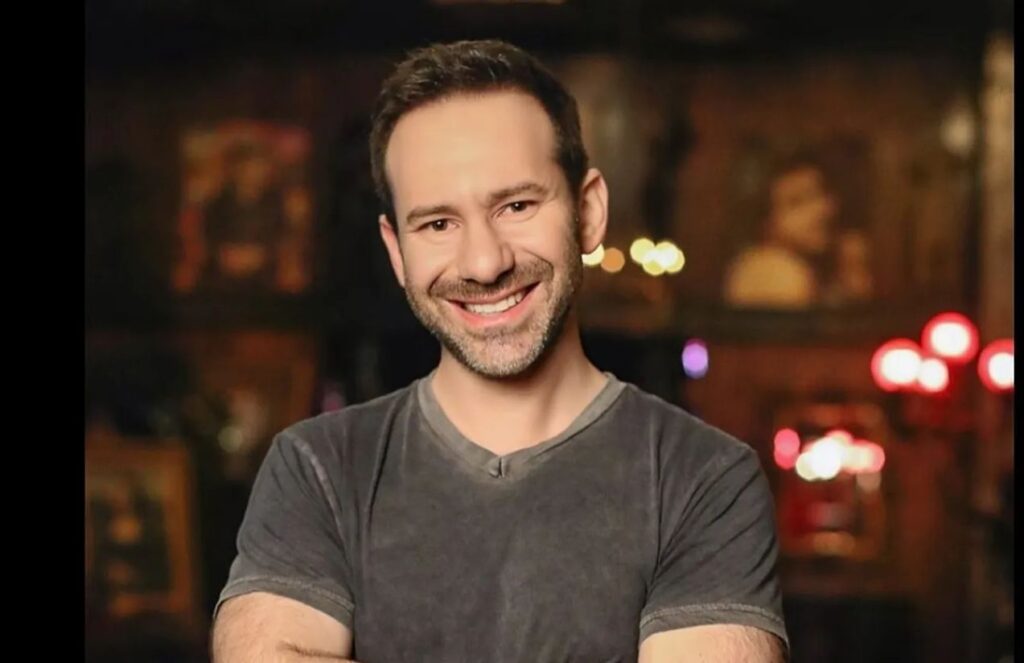 The late CEO of OnlyFans posing for the cameras, smiling and in good spirits