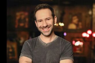 The late CEO of OnlyFans posing for the cameras, smiling and in good spirits