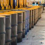 Many barrels piled up with oil in a warehouse