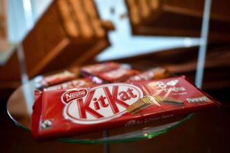 A package of multiple KitKat bars placed on a glass table