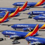 Many airplanes from the famous airline parked at a gigantic airport