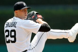 The American pitcher in position to throw a ball in the middle of a game