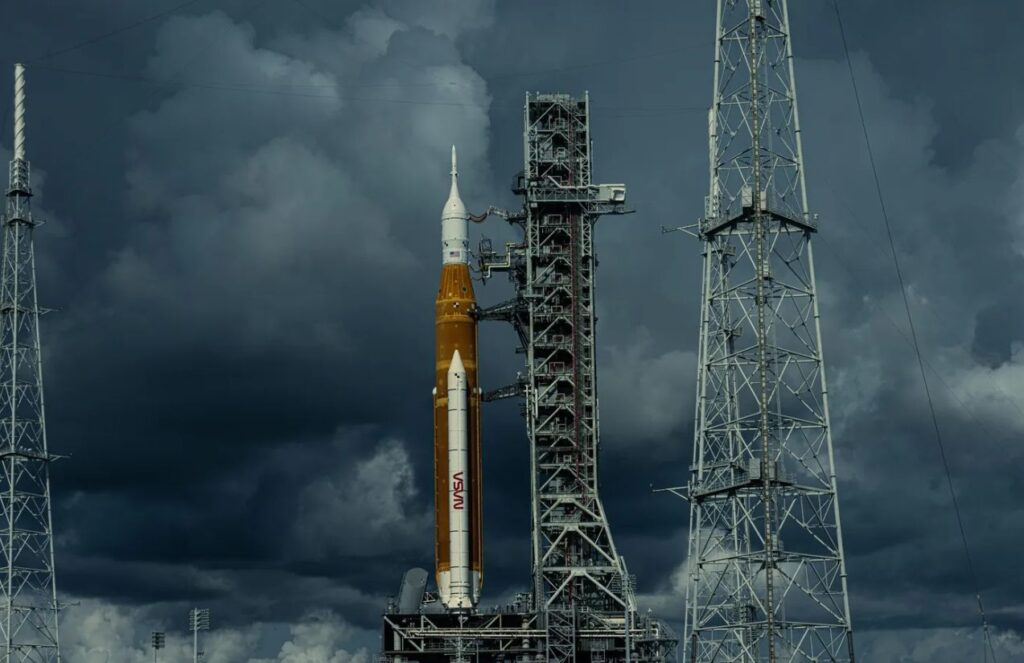 A yellow NASA rocket waiting for the launch signal on a very cloudy day
