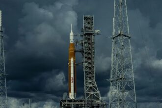 A yellow NASA rocket waiting for the launch signal on a very cloudy day