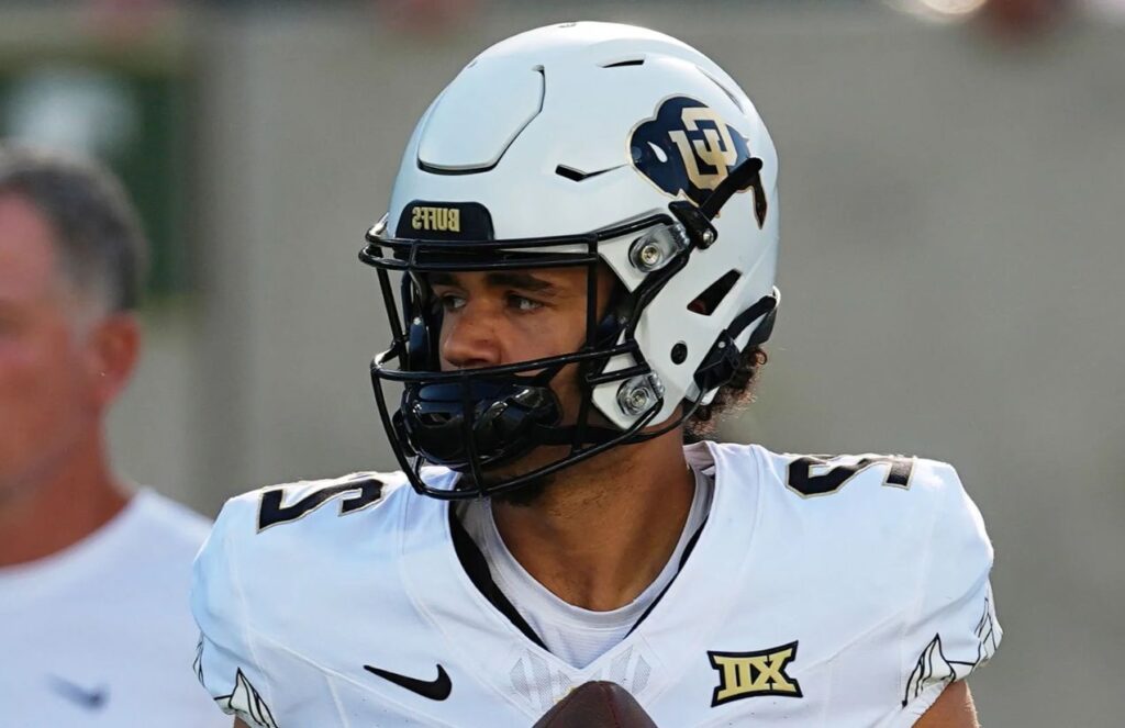 The young deceased player wearing his uniform and helmet in the middle of a game