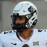 The young deceased player wearing his uniform and helmet in the middle of a game