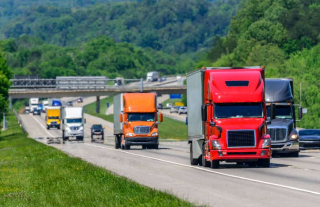 Truckers in the United States face crisis due to rising diesel prices Several heavy trucks driving along a highway