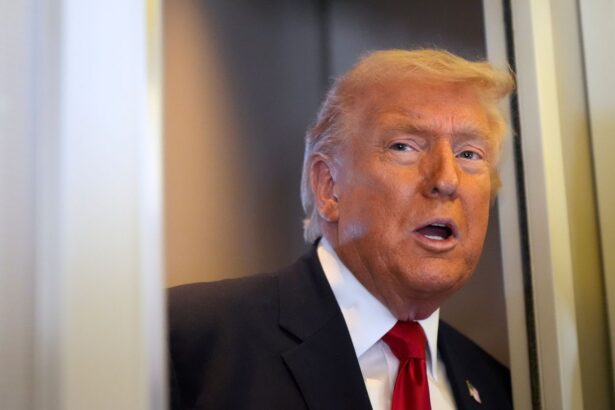 Donald Trump peeking out from a doorway wearing an elegant suit