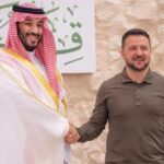 The president of Ukraine and the leader of Saudi Arabia shaking hands with big smiles