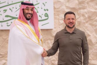 The president of Ukraine and the leader of Saudi Arabia shaking hands with big smiles
