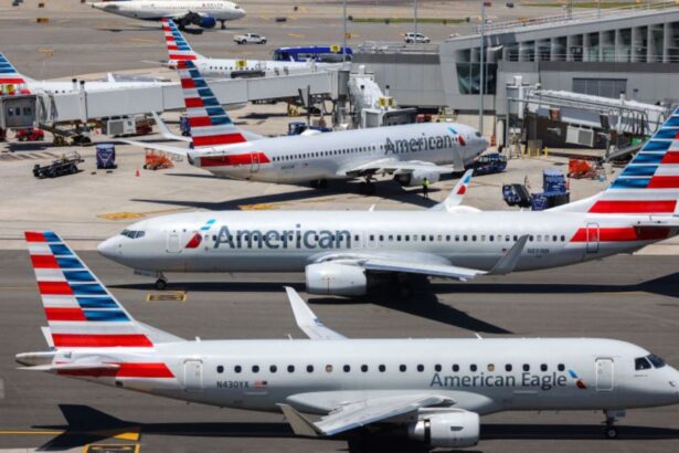Several American Airlines planes parked while receiving their passengers