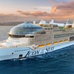 A panoramic photo of a cruise ship in the middle of the sea.