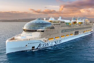 A panoramic photo of a cruise ship in the middle of the sea.