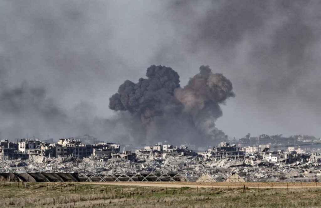 A war zone with heavy destruction and explosions everywhere