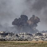 A war zone with heavy destruction and explosions everywhere