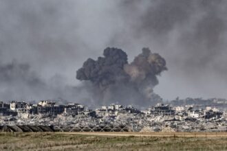 A war zone with heavy destruction and explosions everywhere