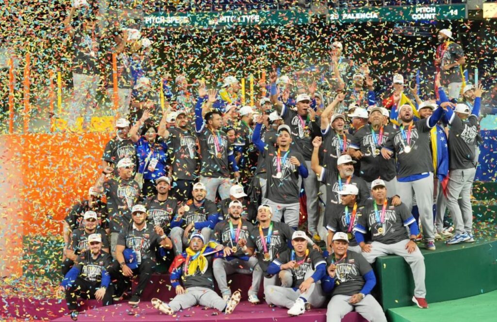 The Venezuelan team celebrating on a stage with lots of confetti and their championship title