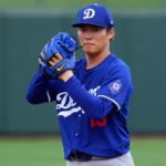The incredible Japanese pitcher on the mound, about to throw the ball in the new blue Los Angeles Dodgers uniform.