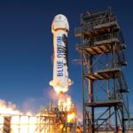 A Blue Origin rocket being launched from a platform.