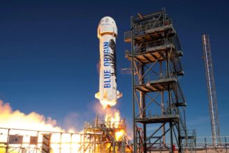 A Blue Origin rocket being launched from a platform.