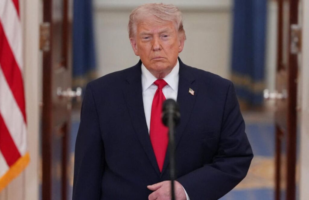 Dangerous escalation Trump intensifies rhetoric as fears of full-scale war with Iran grow Donald Trump wearing an elegant suit while giving a press conference in front of cameras