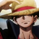 Monkey D. Luffy covering his eyes with his hat while pulling it forward with his hand.