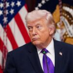 Donald Trump staring intently at someone during one of his presidential speeches.