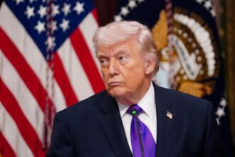 Donald Trump staring intently at someone during one of his presidential speeches.