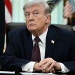 Trump with a very angry expression while looking at someone in the audience during a speech