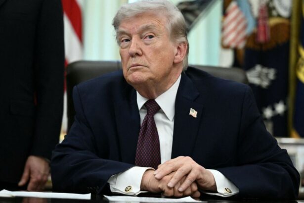 Trump with a very angry expression while looking at someone in the audience during a speech