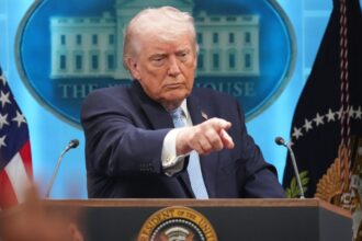 Donald Trump pointing his finger at a person during a conference
